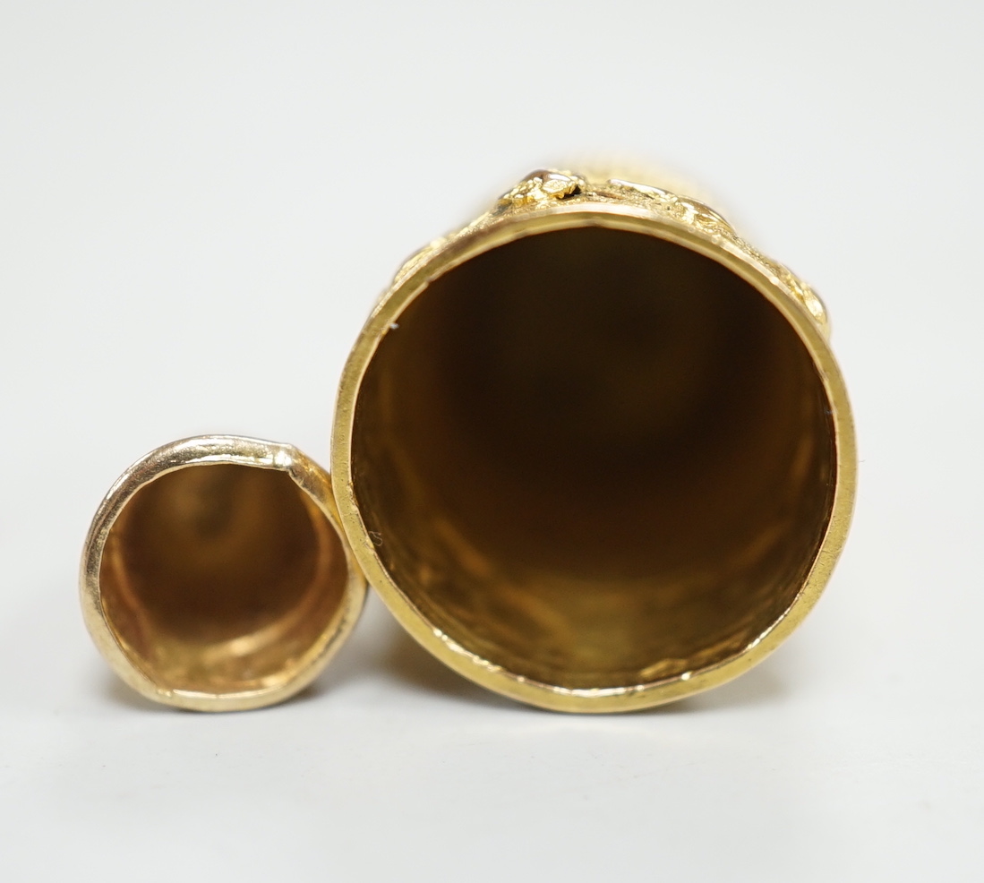 A French yellow metal (18ct poincon mark) thimble, 22mm, 5.4 grams and a tiny 1960's 9ct gold thimble, 9mm, 0.5 grams.